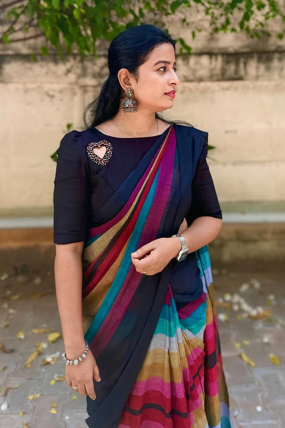 Woman wearing a colorful saree with a plain background
