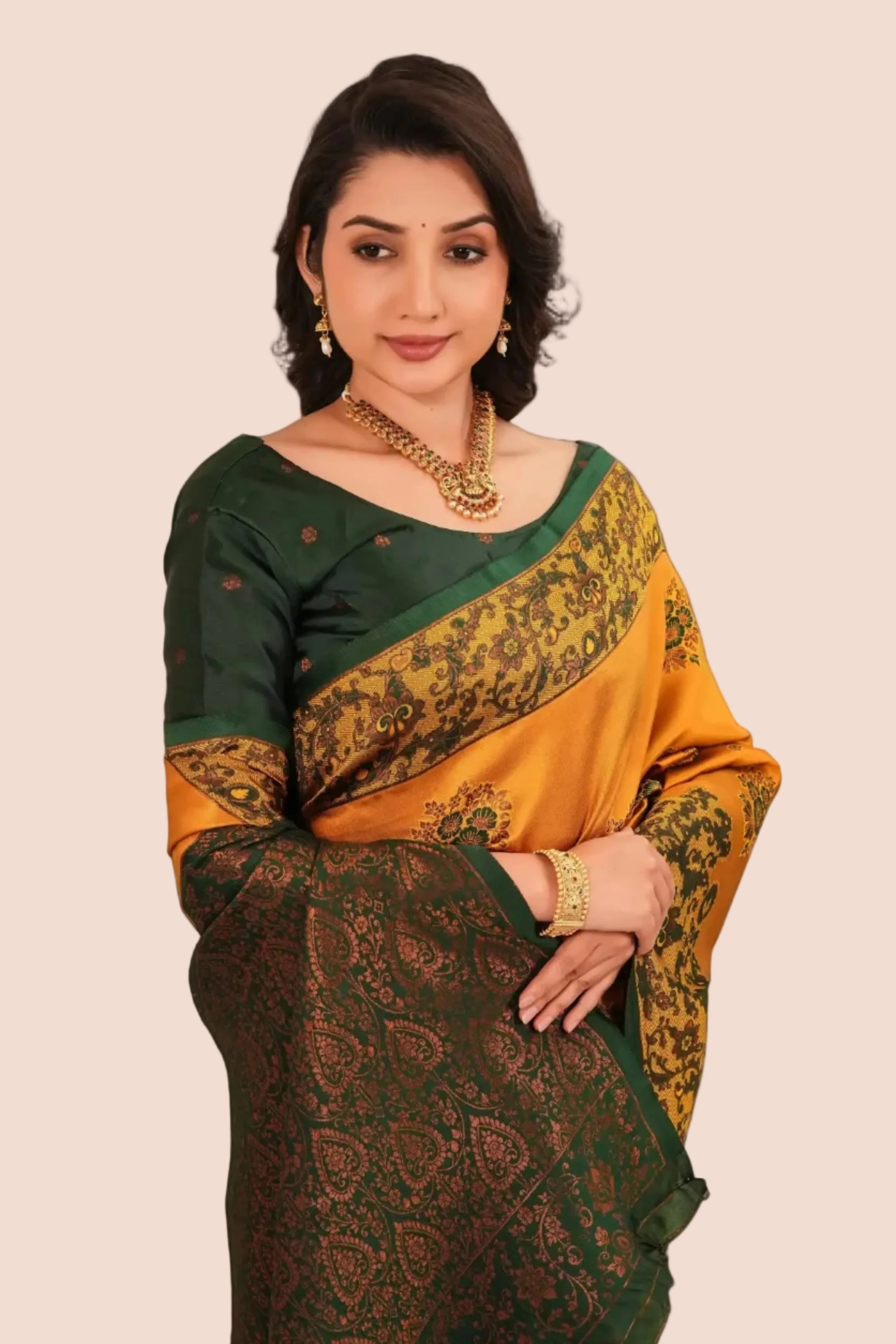 Woman wearing a green and gold saree with a beige background