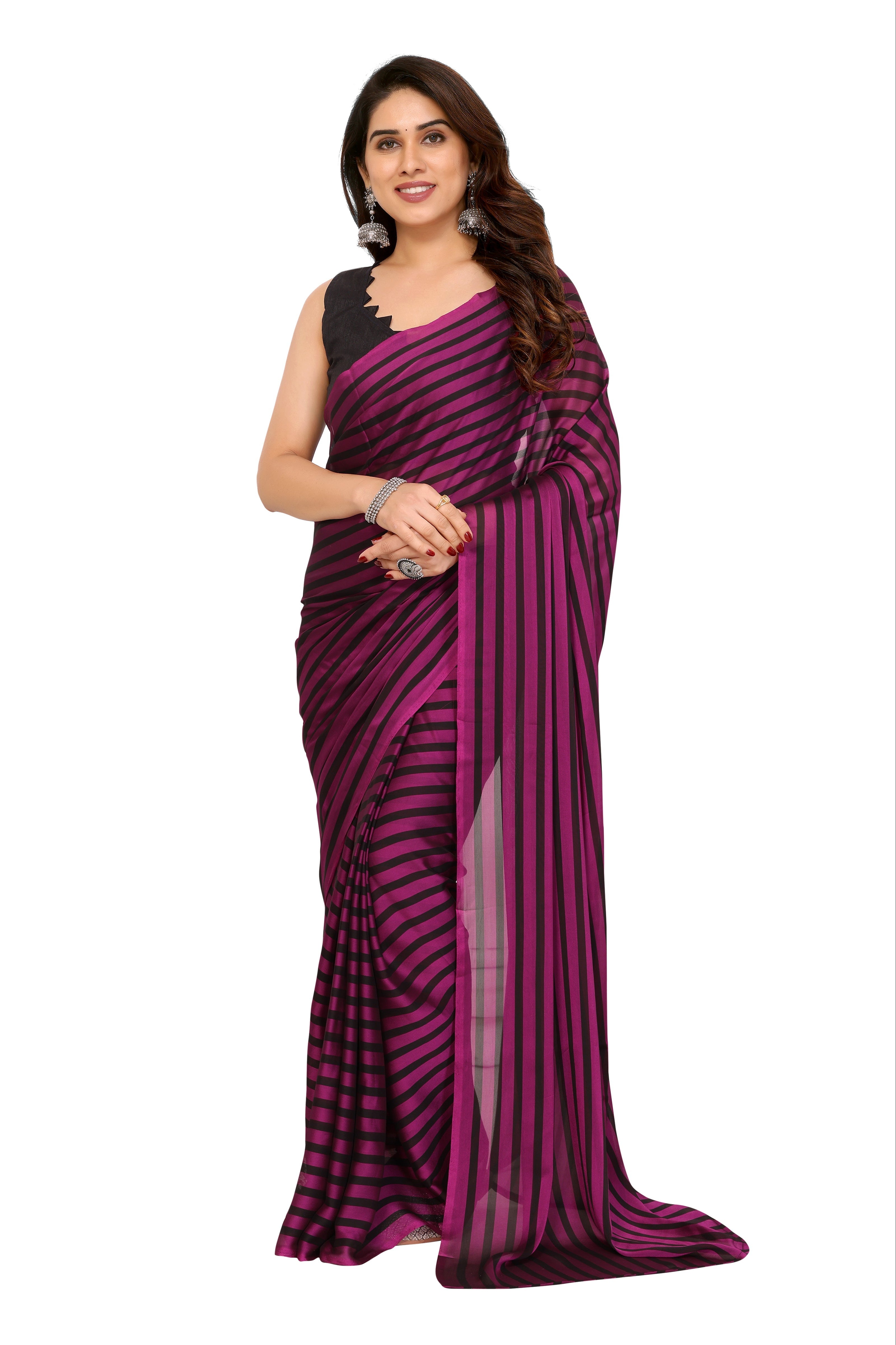 A woman modeling a dark purple and black striped georgette saree with a black sleeveless blouse, set against a plain white background.