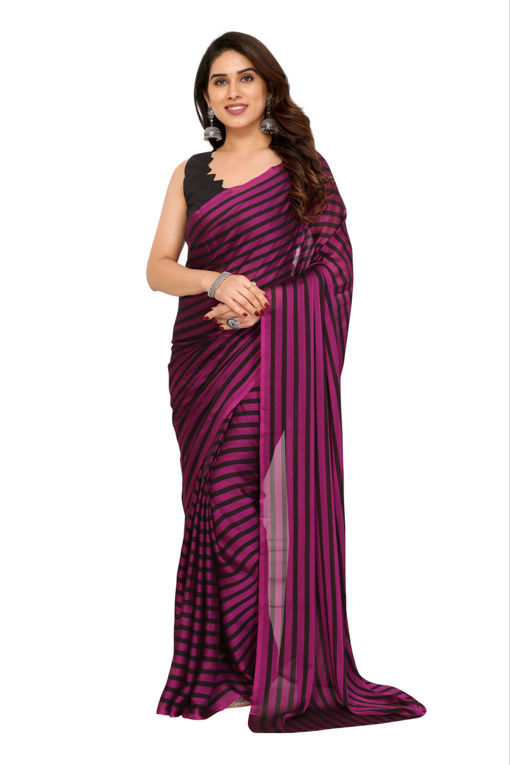 A woman modeling a dark purple and black striped georgette saree with a black sleeveless blouse, set against a plain white background.
